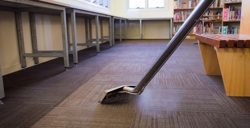 Vacuuming the carpet of the library