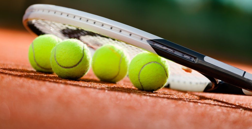 green woolen badminton balls and a racket