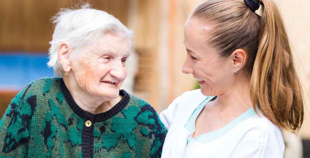 Photo of elderly woman with her caregiver
