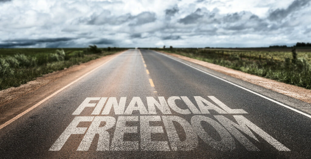 the phrase financial freedom written on the road
