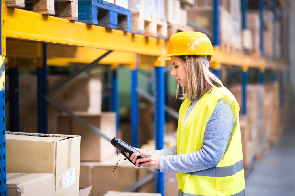 woman working at warehouse barcoding shipment