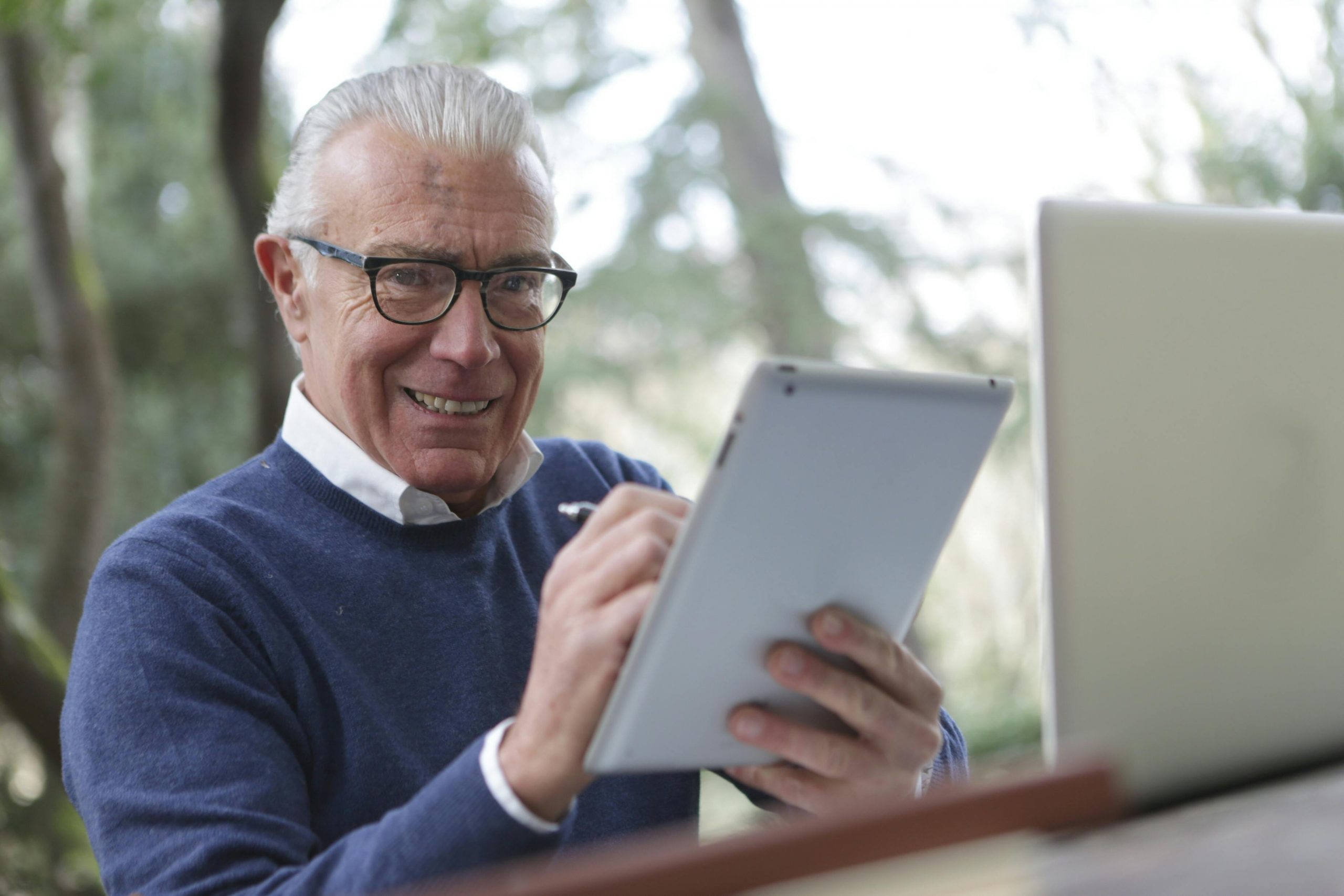 middle-aged man working on a laptop outdoors
